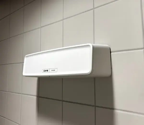 A white CWS PureLine AirBar mounted on a wall in a washroom